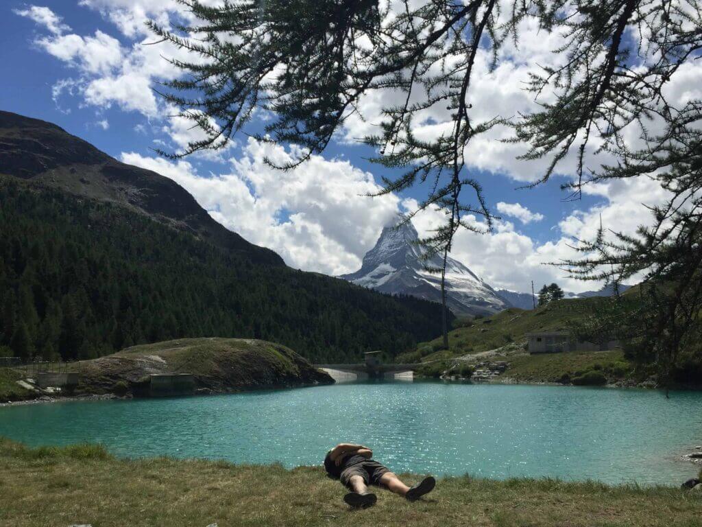 Mr. The Poor Swiss in front of a lake